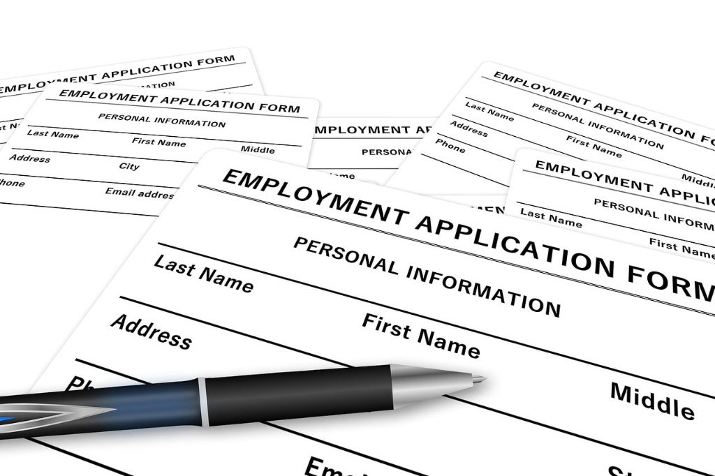 Employment application forms with a pen representing routine administrative paperwork